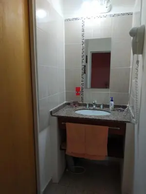 a bathroom with a sink and a mirror at Cabañas Cuncumen in Los Reartes