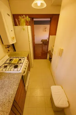 a small kitchen with a stove and a sink at Apartamento Andres in Cordoba