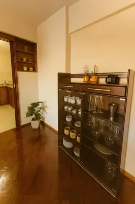 a kitchen with a shelf with glasses and a plant at Apartamento Andres in Cordoba