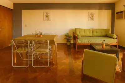 a living room with a table and a couch at Apartamento Andres in Cordoba