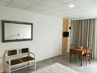 a room with a table and a mirror on the wall at EFE Aparts in Mina Clavero