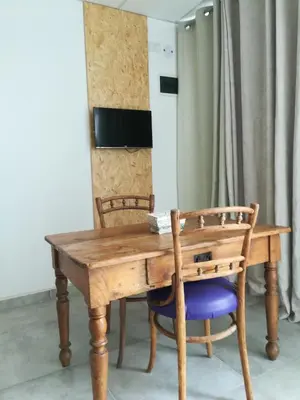 a wooden table with two chairs and a wooden at EFE Aparts in Mina Clavero