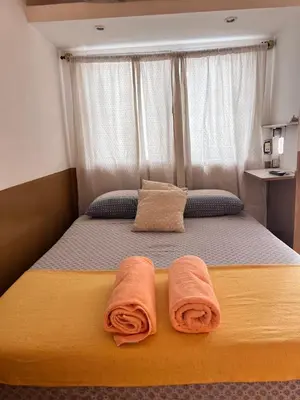 a bedroom with a bed with two towels on it at Alojamiento Cba Observatorio in Cordoba