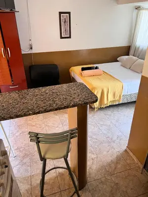 a room with a bed and a table and a chair at Alojamiento Cba Observatorio in Cordoba