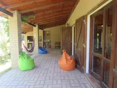 a porch with three colorful bags sitting on it at Casa Las Magnolias in Villa General Belgrano