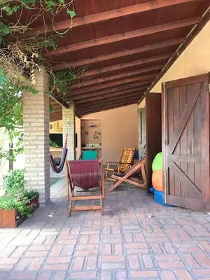 a patio with a barn door and chairs on a patio at Casa Las Magnolias in Villa General Belgrano
