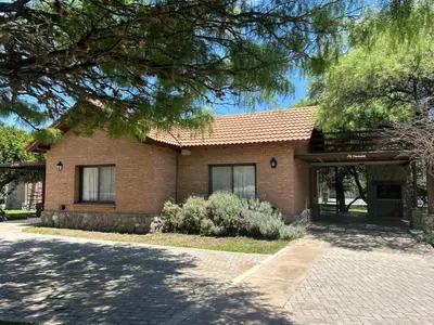 a brick house with a driveway in front of it at La Quinta Resort in Merlo