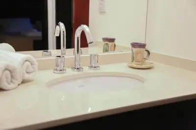 a bathroom counter with a sink and a mirror at La Quinta Resort in Merlo
