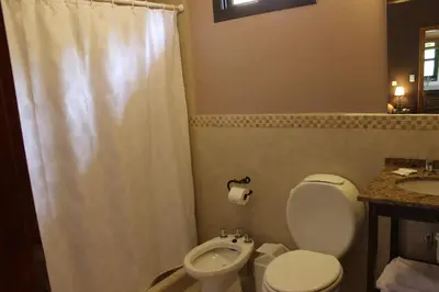 a bathroom with a toilet and a sink at La Quinta Resort in Merlo