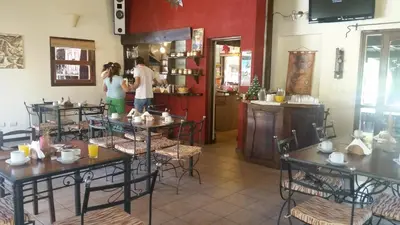 two people standing in a restaurant with tables at La Quinta Resort in Merlo