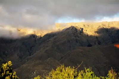 a view of a mountain range with clouds in the background at La Quinta Resort in Merlo