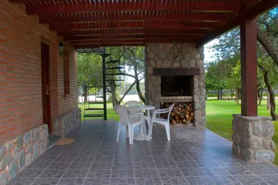 a patio with a table and chairs and a fireplace at La Quinta Resort in Merlo