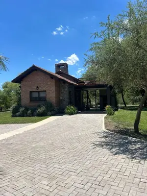 a house with a brick driveway in front of it at La Quinta Resort in Merlo