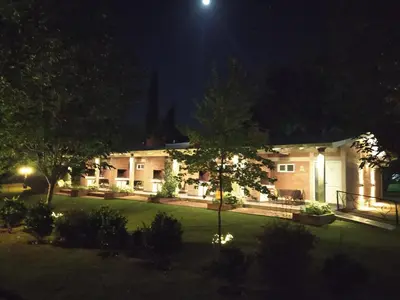 a house with a yard at night at Al Rio Suites in Nono