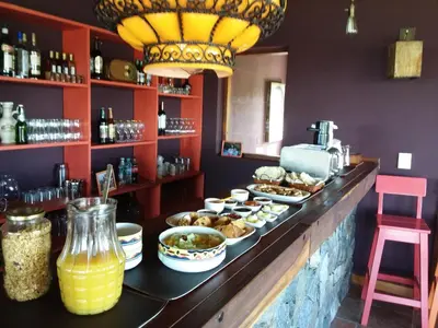 a buffet with food on a counter in a restaurant at Peperina Lago Los Molinos in Villa Ciudad de America