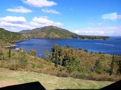 a view of a large lake on a hill at Peperina Lago Los Molinos in Villa Ciudad de America