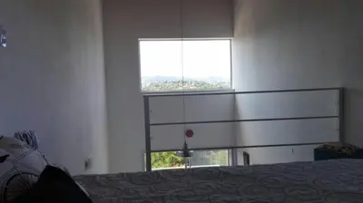 a bedroom with a bed and a large window at Duplex la Delfina 1 in Villa Carlos Paz