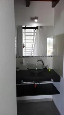 a bathroom with a sink and a mirror at Duplex la Delfina 1 in Villa Carlos Paz