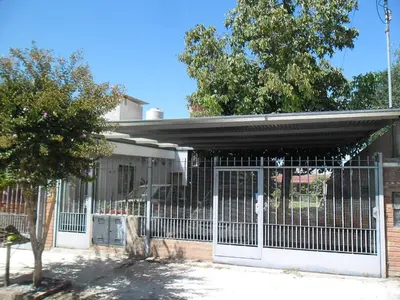 a gate in front of a house at Departamento El Nogal in Alta Gracia