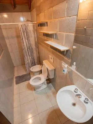 a small bathroom with a toilet and a sink at Alma Tierra in Merlo