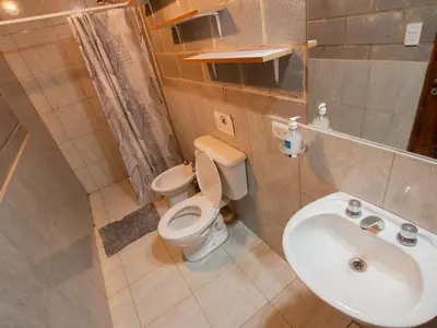 a bathroom with a toilet and a sink at Alma Tierra in Merlo