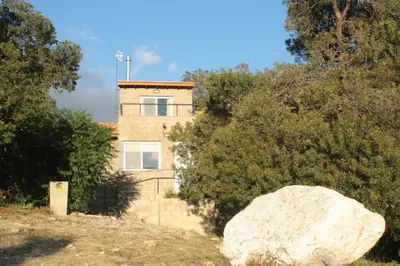 a house with a rock in front of it at Alma Tierra in Merlo