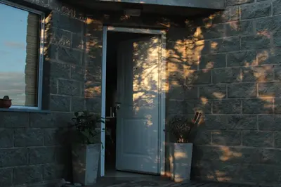 an open door to a brick building with a window at Alma Tierra in Merlo