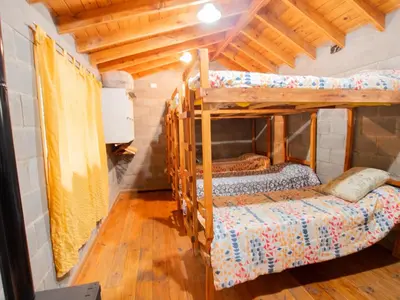 two bunk beds in a room with wooden ceilings at Alma Tierra in Merlo
