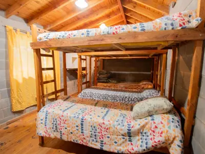 a bedroom with two bunk beds and a ladder at Alma Tierra in Merlo