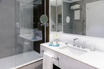 a bathroom with a sink and a shower and a tub at Epic Hotel Villa de Merlo in Merlo
