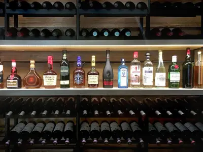 a shelf filled with lots of bottles of wine at Epic Hotel Villa de Merlo in Merlo