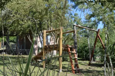 a playground with a slide in a park at Cabañas Kumelkalechi in Los Reartes