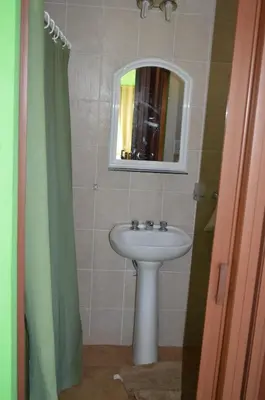 a bathroom with a sink and a mirror at Cabañas Kumelkalechi in Los Reartes
