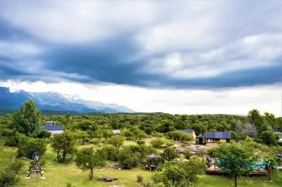 an aerial view of a farm with mountains in the background at Cabañas Quisama in Nono