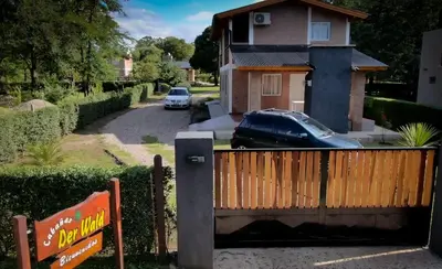 a car parked in front of a house at Der Wald cabañas in Los Reartes