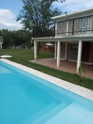a swimming pool in front of a house at Casas Tierra de Ensueno in Villa Parque Siquiman