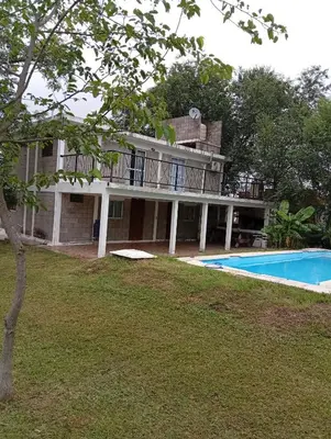 an image of a house with a swimming pool at Casas Tierra de Ensueno in Villa Parque Siquiman
