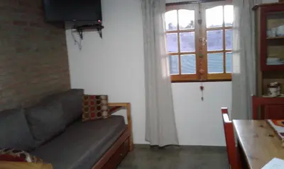 a living room with a couch and a window at Isabel in Alta Gracia