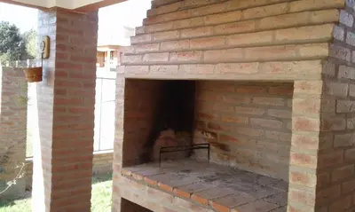 an outdoor brick oven with a brick wall at Isabel in Alta Gracia