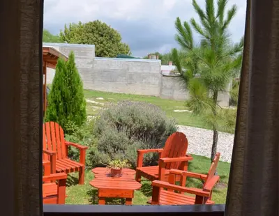 two orange chairs and a table in a yard at Isabel in Alta Gracia