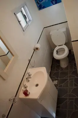 a bathroom with a sink and a toilet at Cabaña Su Estar in Villa de Las Rosas