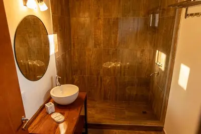 a bathroom with a sink and a shower at Bandera Blanca Cabañas & Suites in San Javier