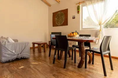 a dining room with a table and chairs at Bandera Blanca Cabañas & Suites in San Javier