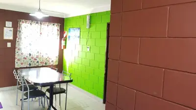 a room with a table and green walls at Residencia Jose Maria in Santa Rosa de Calamuchita