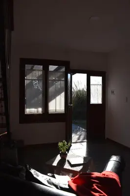 a living room with a couch and some windows at Celandine in Los Reartes