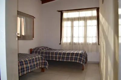 a room with two beds and a window at Celandine in Los Reartes