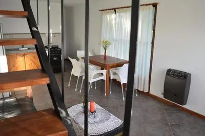 a kitchen and dining room with a table and chairs at Celandine in Los Reartes