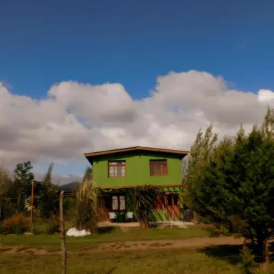 a green house in the middle of a field at Celandine in Los Reartes