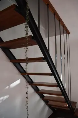 a wooden staircase with chains hanging from it at Celandine in Los Reartes