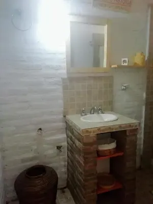 a bathroom with a sink and a mirror at El Campito casa frente al río in Villa Carlos Paz